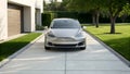 Silver Tesla Model S parked on driveway modern home Royalty Free Stock Photo