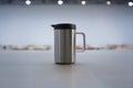 Silver thermal mug with black lid and handle stainless steel Royalty Free Stock Photo