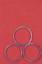 Silver three rings with red background Royalty Free Stock Photo