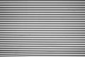 Silver tin iron corrugated wall with horizontal stripes from a metal profile of a metal sheet. Texture, background. grey wall Royalty Free Stock Photo