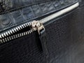 Silver-tone zip fastener on a black leather bag Royalty Free Stock Photo