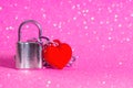 Silver toned padlock with a heart shaped pendant Royalty Free Stock Photo