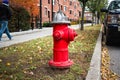 Silver-topped traditional red American style fire hydrant outside a modern housing block Royalty Free Stock Photo