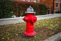 Silver-topped traditional red American style fire hydrant outside a modern housing block Royalty Free Stock Photo