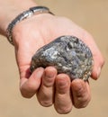 Silver traces in the rock in his hand