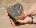 Silver traces in the rock in his hand