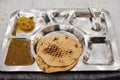 Silver tray with chapati, dal and sabji puree free food for pilgrims in langar at Gurudwara Bangla