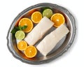 A silver tray with fresh halibut fillets and slices of orange and lime Royalty Free Stock Photo