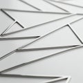 Silver triangular frames arranged in a repeated pattern on a smooth white surface. Royalty Free Stock Photo