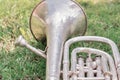 Silver trombone on th grass Royalty Free Stock Photo