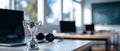 Silver trophy cup on desk with blurred laptops and headphones in modern workspace environment Royalty Free Stock Photo