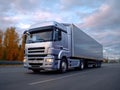 Silver truck driving on a highway with autumn trees in the background, Royalty Free Stock Photo