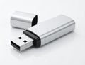 Silver USB flash drive with cap beside it on a white background Keywords: USB drive, flash drive, storage, data Royalty Free Stock Photo