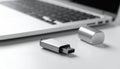 Silver USB Flash Drive Disconnected From Laptop Keyboard on White Surface USB drive storage Royalty Free Stock Photo