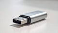 Silver USB flash drive with USBA connector on a light grey surface storage memory Royalty Free Stock Photo