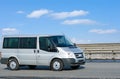 Silver van on road with blue horizon