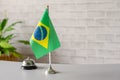 Silver vintage bell with national flag of Brazil on reception desk with copy space. Hotel service. Travel, tourism. Royalty Free Stock Photo