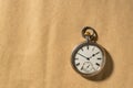 Silver vintage pocket watch with hands and numbers on a round dial. Old retro clock on a beige background with place for Royalty Free Stock Photo