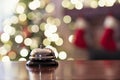 Silver vintage  reception bell on desk of guesthouse, hotel and color shining garland on christmas tree on background. Christmas Royalty Free Stock Photo