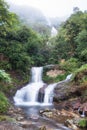 Silver waterfall or Thac Bac on fog in rainy season Royalty Free Stock Photo