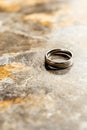 Silver wedding band on textured stone surface in natural light Royalty Free Stock Photo