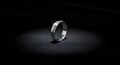 Silver Wedding Ring on Dark Background with Spotlight Effect Royalty Free Stock Photo