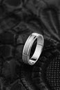 Silver wedding ring with with glossy and matte surface on black background Royalty Free Stock Photo