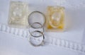 Silver wedding rings and engagement ring and two bottles of parfume