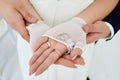 silver wedding rings on the palms of the bride. the groom holds the bride's hands Royalty Free Stock Photo