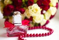 Silver wedding rings with tiny diamonds red perfume bottle Royalty Free Stock Photo