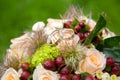 Silver wedding rings on top of bride flower bouquet