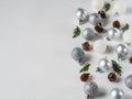 Silver and white gliter Christmas ball, cones and Christmas tree branch border flat lay. Copy space Royalty Free Stock Photo