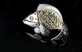 Silver or white gold brooch with yellow sapphire in shape of fish. Royalty Free Stock Photo