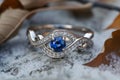 Silver or white gold ring with diamonds and blue sapphires closeup. Precious gems and metals, natural gemstone jewelry Royalty Free Stock Photo