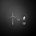 Silver Wind turbine and light bulb with leaves as idea of eco-friendly source of energy icon isolated on black Royalty Free Stock Photo