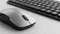 Silver wireless computer mouse and black keyboard on white sur Royalty Free Stock Photo