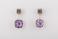 Silver womens earrings with purple diamond isolated on white background