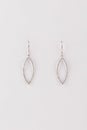 Silver womens earrings in the shape of an ellipse with diamonds isolated on a white background.