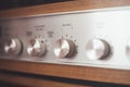 Silver wooden vintage amplifier: Close up of control knobs Royalty Free Stock Photo