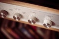 Silver wooden vintage amplifier: Close up of control knobs Royalty Free Stock Photo