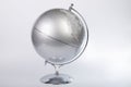 Silver World atlas globe isolated on a gray background