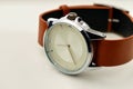 Silver wrist watch with a brown double-sided single-piece leather strap. Zulu or nato strap. White background Royalty Free Stock Photo