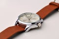 Silver wrist watch with a brown single-piece leather strap. Double-sided nato strap. White background Royalty Free Stock Photo