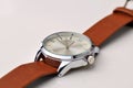 Silver wrist watch with a brown single-piece leather strap. Double-sided zulu strap Royalty Free Stock Photo