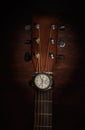 Silver wrist watch on a guitar fretboard Royalty Free Stock Photo