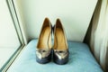 Silvering bride shoes on wedding day on blue pillow