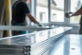 silvermetal table, professionals fitting window frames, softly out of focus Royalty Free Stock Photo