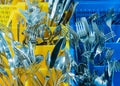 Silverware and cutlery in colorful palstic ocntainer in an industrial restaurant kitchen