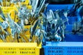 Silverware and cutlery in colorful palstic ocntainer in an industrial restaurant kitchen