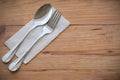 Silverware, fork spoon and paper put on wooden dining table set in left hand focused for make copy space on right hand image for
